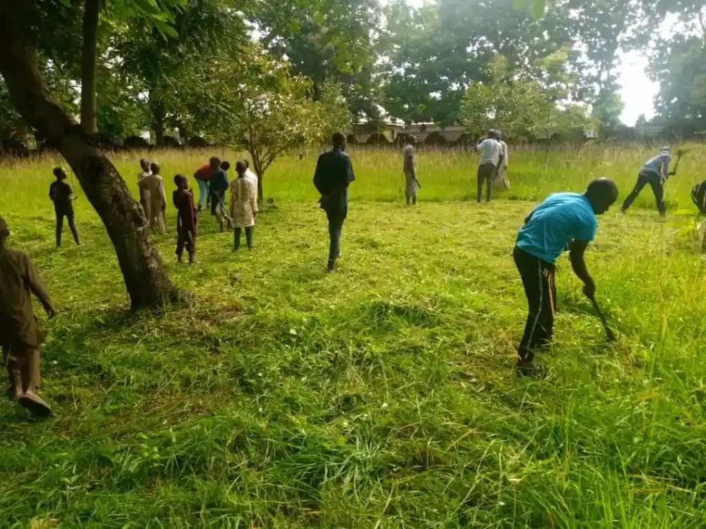 Christians Join Muslims To Clear Grass